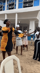 Women and children dance barefoot in Badagry, Nigeria