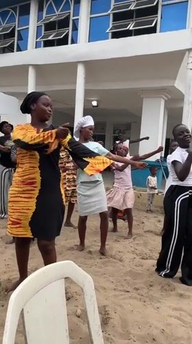 Women and children dance barefoot in Badagry, Nigeria