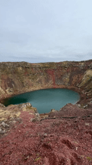 Tourists visit Kerið crater lake under overcast skies