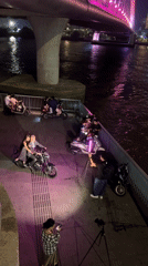 Nighttime photoshoot under illuminated bridge in Thủ Đức, Vietnam