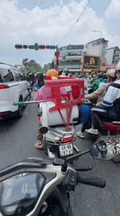 Scooter with pesticide sprayer stops at Da Lat traffic light