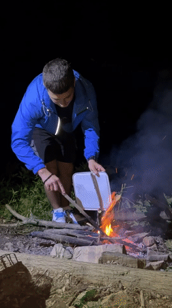 Campfire, fishing, and grilling by a Bulgarian lake at dusk