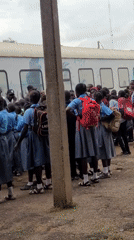 School group at a train, street life in an African market setting