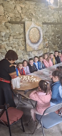 Traditional Bulgarian cooking demonstration draws children in Razhdavitsa