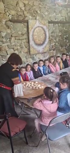 Traditional Bulgarian cooking demonstration draws children in Razhdavitsa