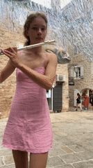 Woman performs flute music in Budva square