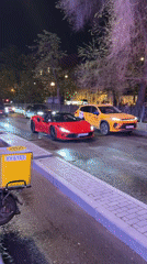 Red Ferrari convertible spotted driving through wet Moscow streets