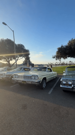 Classic lowriders gathered at a San Diego outdoor car meet