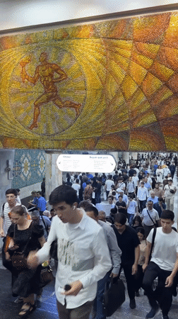 Tashkent subway station documented with train arrival, mosaic art