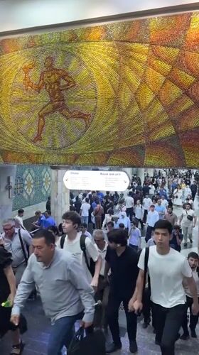 Tashkent subway station documented with train arrival, mosaic art