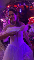 Women dance in costumes at lit venue in Thailand