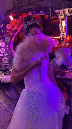 Women dance in costumes at lit venue in Thailand