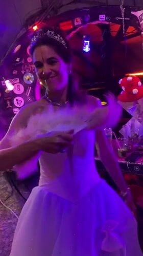Women dance in costumes at lit venue in Thailand