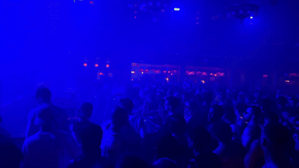 Barcelona streets after midnight — clubs, scooters, and shuttered storefronts