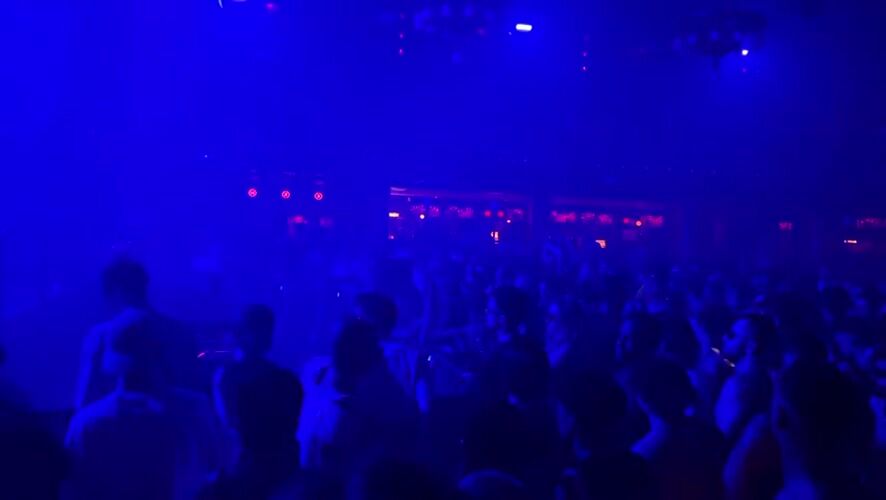 Barcelona streets after midnight — clubs, scooters, and shuttered storefronts