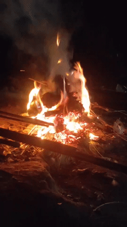 Nighttime open fire burning amid debris in Lhokseumawe