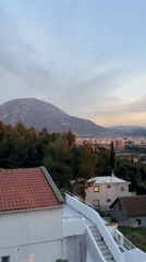 Tourist enjoys drinks on coastal balcony in Montenegro