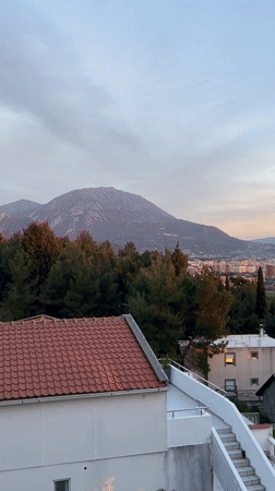 Tourist enjoys drinks on coastal balcony in Montenegro