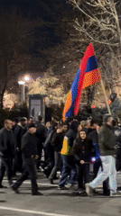 Crowd gathers in central Yerevan with police presence, flags visible