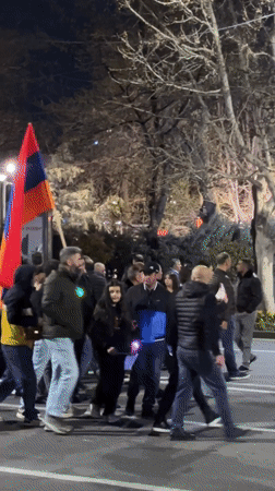 Crowd gathers in central Yerevan with police presence, flags visible