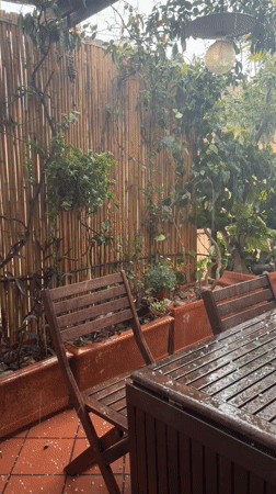Rainstorm soaks outdoor furniture on Rome patio