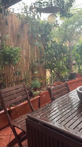 Rainstorm soaks outdoor furniture on Rome patio