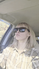 Woman sings along to music in car in Chaikovsky