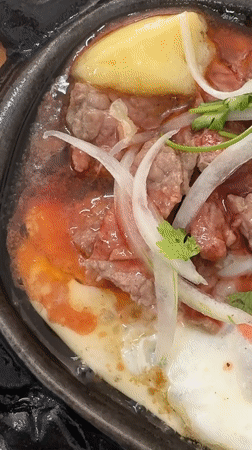 Sizzling Vietnamese Bò Né breakfast captured in Nha Trang