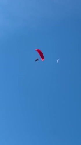 Red paraglider spotted flying near Kazanlak at dawn