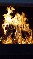 Logs burning in a Chișinău fireplace, flames at full heat