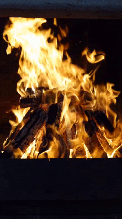 Logs burning in a Chișinău fireplace, flames at full heat
