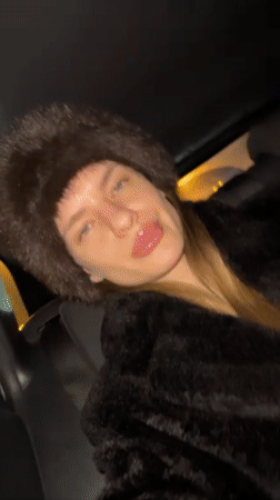 Woman poses playfully in car in Berlin