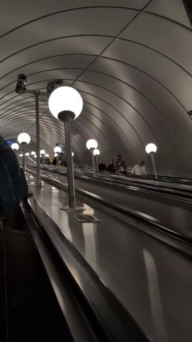Descending the deep escalators of the Saint Petersburg Metro