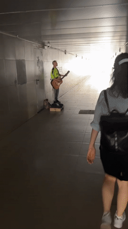 Street musician performs acoustic guitar in Krasnodar underpass