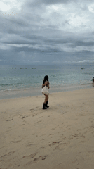 Morning beach activity documented at Kuta Selatan under cloudy skies