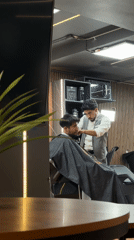 Late-night haircut captured at modern Puebla barbershop