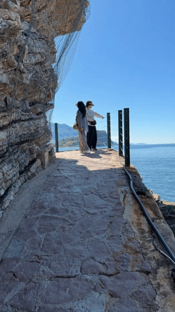 Medieval island town viewed from Budva waterfront walkway