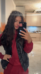 Woman Takes Selfie in Apartment Wearing Burgundy Tracksuit