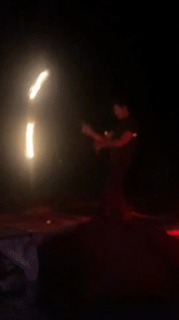 Fire performers entertain beachgoers at night in Ban Haad Rin