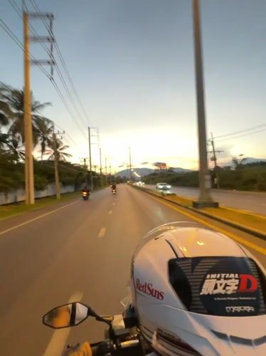 Motorcyclists navigate Kathu roads during sunset commute