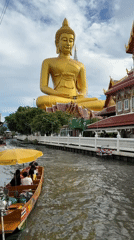Bangkok temple visitors document golden Buddha statues and canal scenes