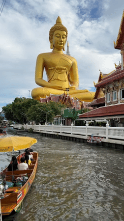 Bangkok temple visitors document golden Buddha statues and canal scenes