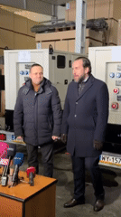 Officials hold warehouse press conference in Ukraine with generators