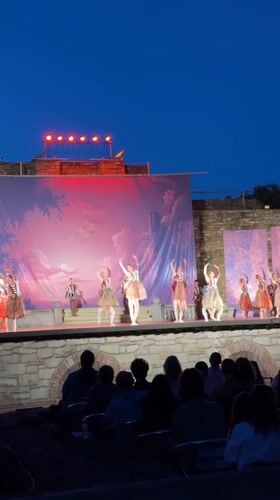 Outdoor dance performance on a mural-backed stage in Veliko Tarnovo