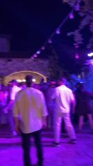 Outdoor nighttime celebration with dancing and DJ near Ramallah