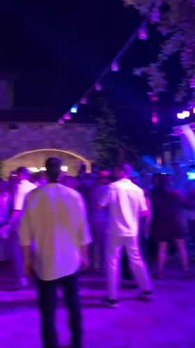 Outdoor nighttime celebration with dancing and DJ near Ramallah