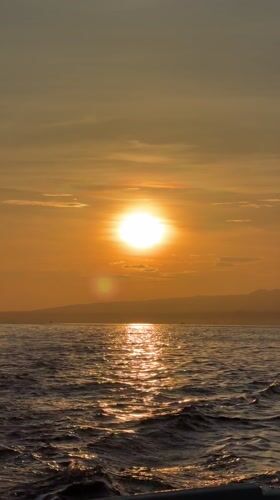Golden sunrise captured over ocean waters near Banjar, Indonesia