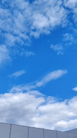 Shifting summer skies over Khorugvino, storm clouds building