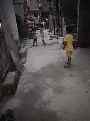 Kids play basketball in a narrow Delhi alleyway