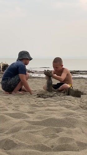 Beach afternoon in Krasnoturansk: sand, a green spider, and shoreline play